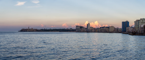 Naklejka premium Panoramic view of the Old Havana City, Capital of Cuba, during a colorful cloudy sunset.