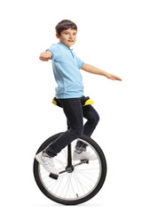 Boy riding a unicycle and looking at the camera © Ljupco Smokovski