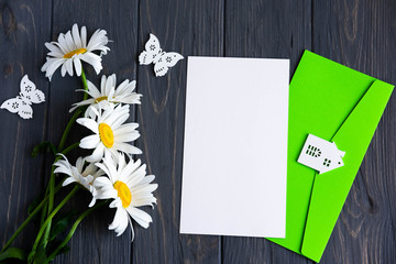Letter mockup for greeting inscription, promotions, discounts with daisies and an envelope on a...
