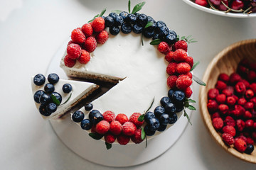 Close up. Creamy mascarpone cheese cake with strawberry and winter berries. New York Cheesecake. Close up. Christmas dessert. Healthy food. Creative atmospheric decoration.