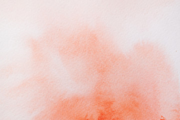 Obraz na płótnie Canvas Trend photo on the theme of fashionable orange hue this season. Bright smear of watercolor paint on a white paper background.