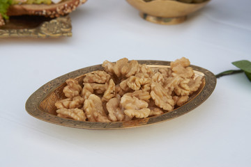Walnuts kernel in metal bowl, close-up, healthy snack food.
