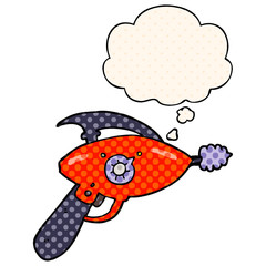cartoon ray gun and thought bubble in comic book style