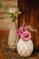 bouquet of roses in a vase on wooden table