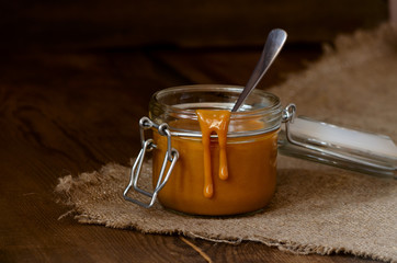 Caramel in the jar on the table