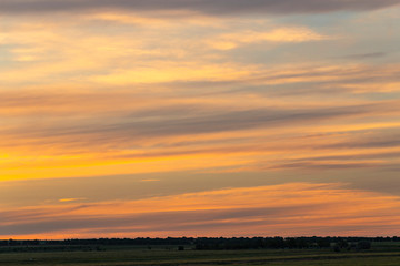 Landscape with bloody sunset. The terrain in southern Europe. Tragic gloomy sky. Purple-magenta clouds.