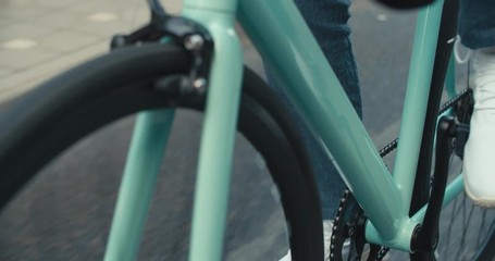 Young hipster man riding bike
