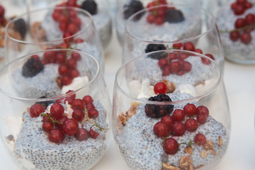 Glass of fresh passion fruit cocktail with berries and yogurt.