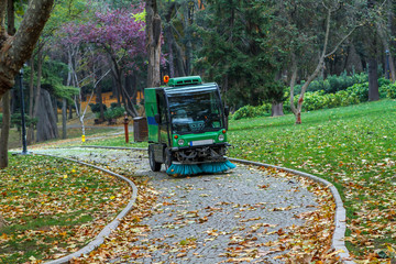Street sweeper removing leaves