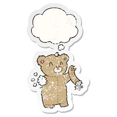 cartoon teddy bear with torn arm and thought bubble as a distressed worn sticker