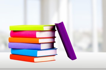 Colorful books collection on background.