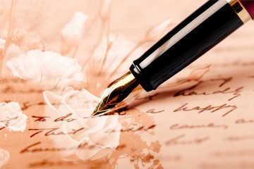 Fountain pen on handwritting background, close-up view
