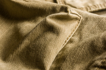 clothing items stonewashed cotton fabric texture with seams, clasps, buttons and rivets, macro
