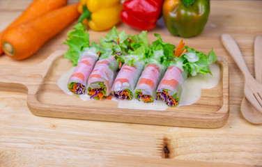 Close up fresh vegetables salad and crab sticks are wrapped with noodle