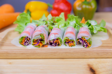 Close up fresh vegetables salad and crab sticks are wrapped with noodle
