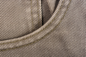 clothing items stonewashed cotton fabric texture with seams, clasps, buttons and rivets, macro
