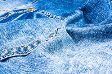 clothing items blue stonewashed faded jeans cotton fabric texture with seams, clasps, buttons and...