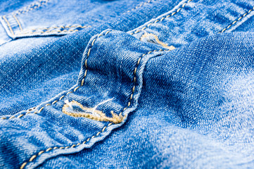 clothing items blue stonewashed faded jeans cotton fabric texture with seams, clasps, buttons and...