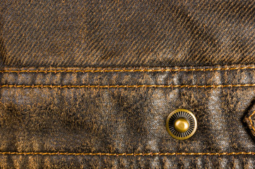 clothing items stonewashed cotton fabric texture with seams, clasps, buttons and rivets, macro