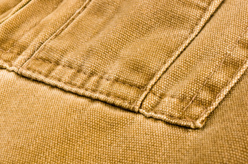 clothing items stonewashed cotton fabric texture with seams, clasps, buttons and rivets, macro