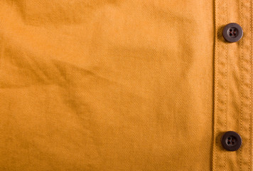 clothing items stonewashed cotton fabric texture with seams, clasps, buttons and rivets, macro