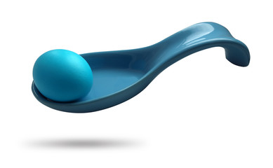 Colorful blue egg on a naked spoon, isolated on a white background, as a concept of festive events. Easter holiday.