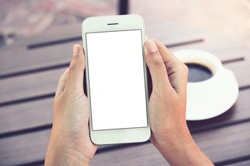 Woman holding smartphone with blank screen in cafe. clipping path.