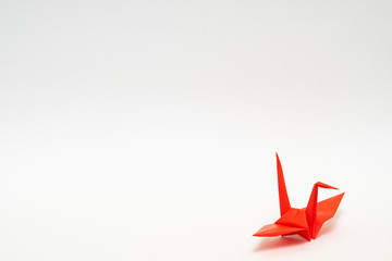 red origami paper crane on white background