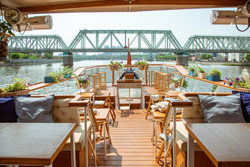 The interior of the urban river ship, with a panoramic view of the urban landscape. The concept of tourism, recreation, walking around the city, rest in the city. River transport.