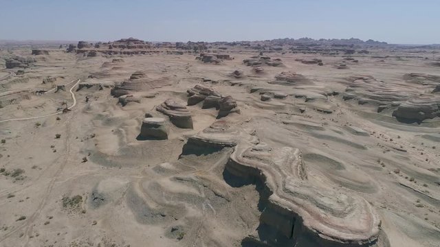 Aerial view of sandy rocks desert in the World Town of Demons of Karamay, The Haunt of Demons desert is in the  Northwest China's Xinjiang Uyghur Autonomous Region. Dusty and arid land desert