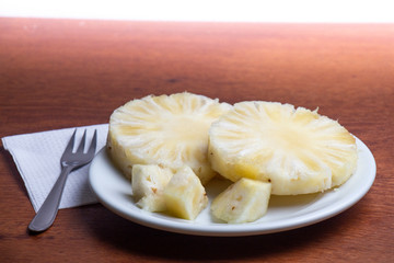 a plate with slices of pineapple