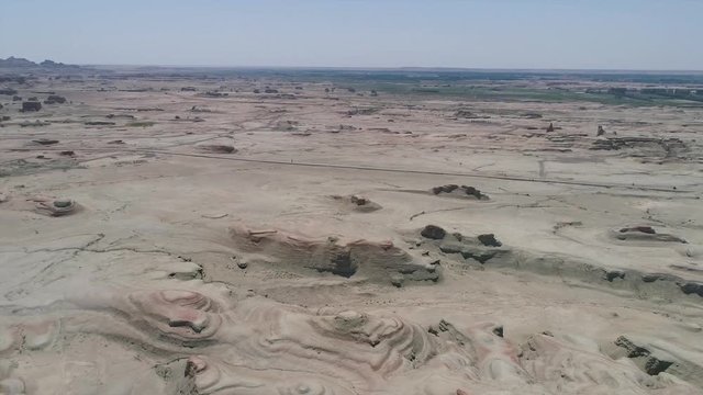 Aerial view of sandy rocks desert in the World Town of Demons of Karamay, The Haunt of Demons desert is in the  Northwest China's Xinjiang Uyghur Autonomous Region. Dusty and arid land desert
