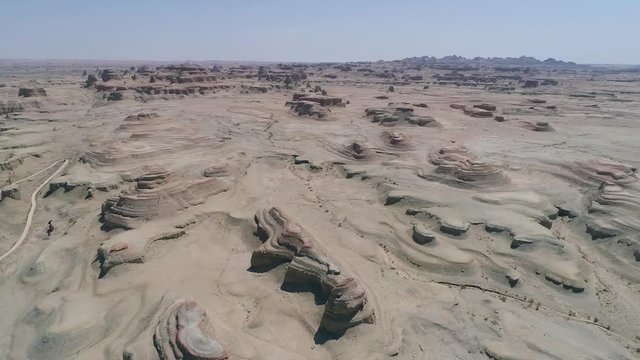 Aerial view of sandy rocks desert in the World Town of Demons of Karamay, The Haunt of Demons desert is in the  Northwest China's Xinjiang Uyghur Autonomous Region. Dusty and arid land desert