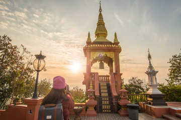 Tourist woman looking to the beautiful sunrise over Wat Phra That Doi Phra Chan one of the most...