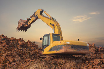 yellow excavator on construction site