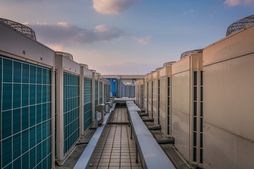 This photograph represents an industrial air conditioning unit cooling system on the roof of a...