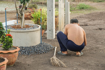old man with no shirt for gardening at home in holidays