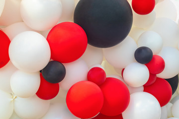 Large and small balloons together, white, black and red bubbles beautiful holiday texture, background