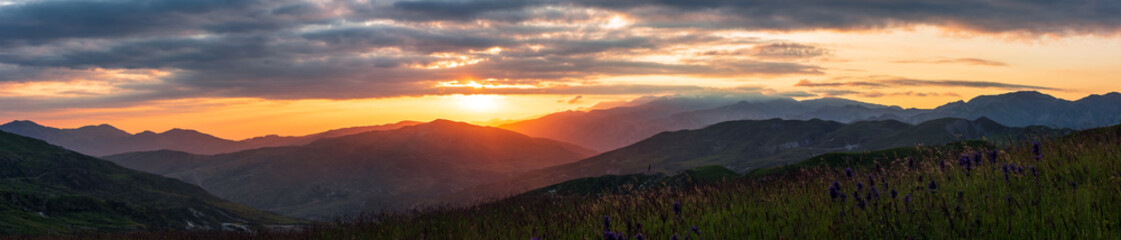 Wide panorama of colorful sunset in the mountains