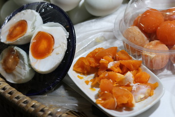 Chinese salted duck eggs on bamboo basket for sale in fresh market. Slice of salted egg yolk. The preservation with salt of the egg menu.