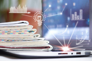 Business Concept. Laptop and Newspapers with Virtual Graphs and Charts      
