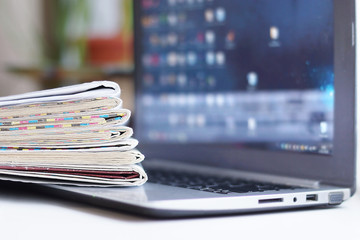 Newspapers and Laptop. Different Concepts for News -  Network or Traditional Tabloid Journals. Data Sources - Electronic Screen of Computer or Paper Pages of Magazines, Internet or Papers 