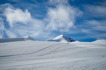 Fototapeta na wymiar The image of snowboarders on a snowy mountain top.