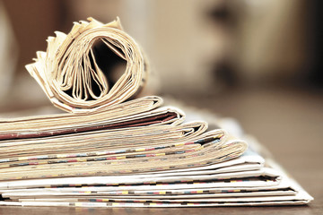 Newspapers and Magazines. Pages with News Folded adn Rolled and Stacked in Pile. Tabloid Journals with Headlines and Articles