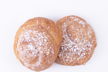 Top view of two freshly baked puff pastries with powdered sugar on top