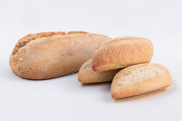 Homemade wholemeal bread with small loaf of bread on white background