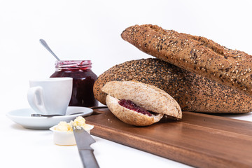 two small pieces of bread with jam. Raspberry jam and espresso coffee