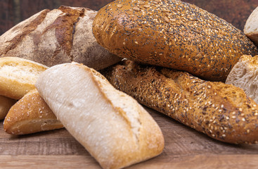Assortment of baked bread on table background. food concept