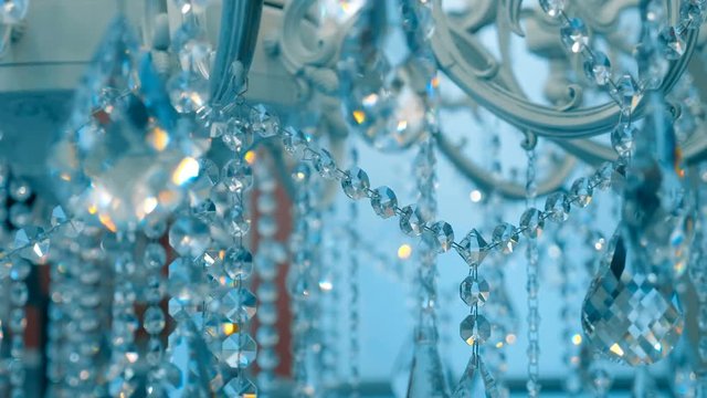 Amazingly beautiful luxury chandeliers with sparkling crystal candelabra sold in the store. Shot in motion