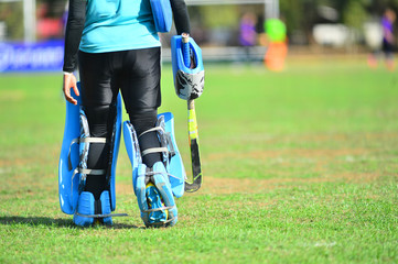 Fototapeta premium woman hockey playing hockey in the green field